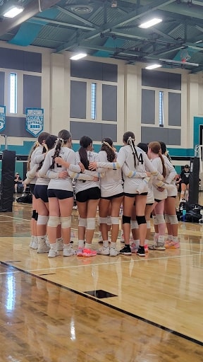 The girls huddle to encourage each other prior to the start of their game. (Courtesy Photo by Maya Boustani)