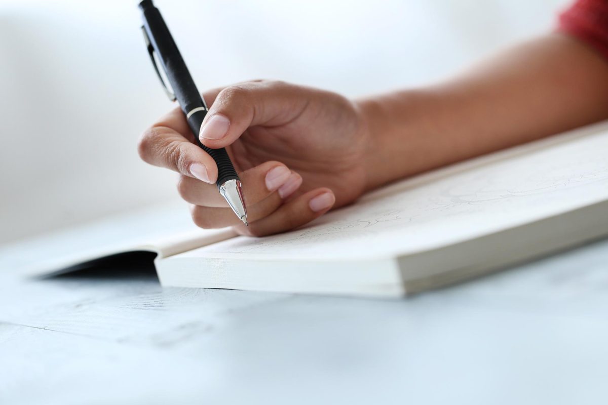 An individual poised with a pen, ready to write, similar to the students of the club. (Courtesy of Racool Studio) 