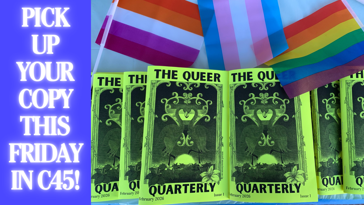 Copies of Queer Quarterly’s first issue of their zine, adorned by queer flags, spread out on a table.
